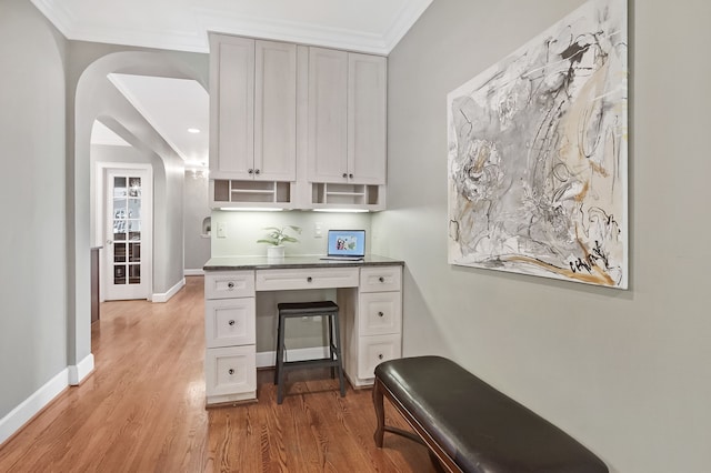 office with crown molding, baseboards, and wood finished floors