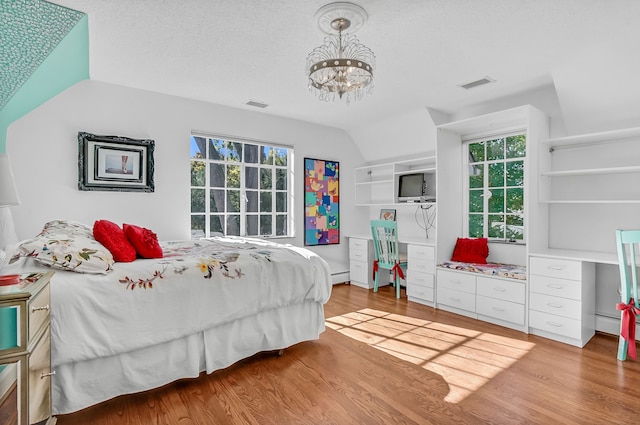 bedroom featuring visible vents, light wood-style flooring, and multiple windows