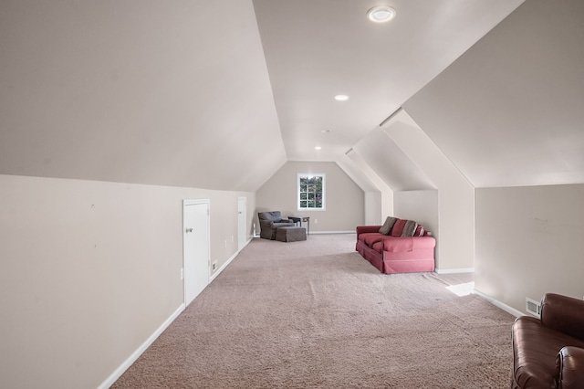 additional living space featuring carpet, visible vents, vaulted ceiling, and baseboards