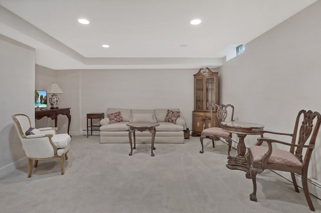 carpeted living room featuring recessed lighting, baseboard heating, and baseboards