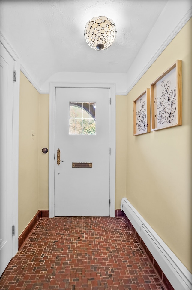 entryway with brick floor, a baseboard radiator, and baseboards