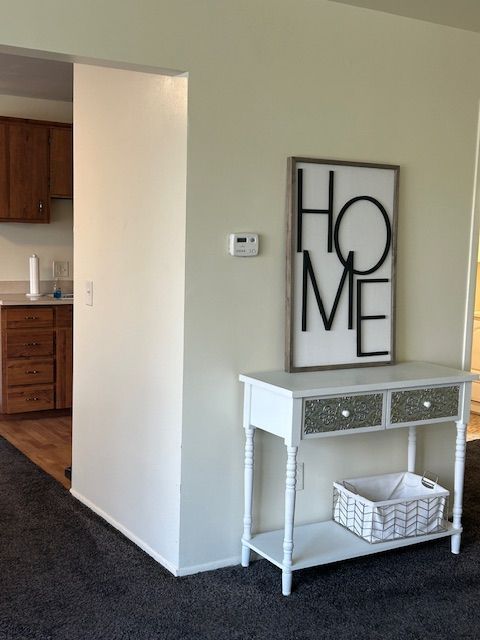 hallway with carpet and baseboards