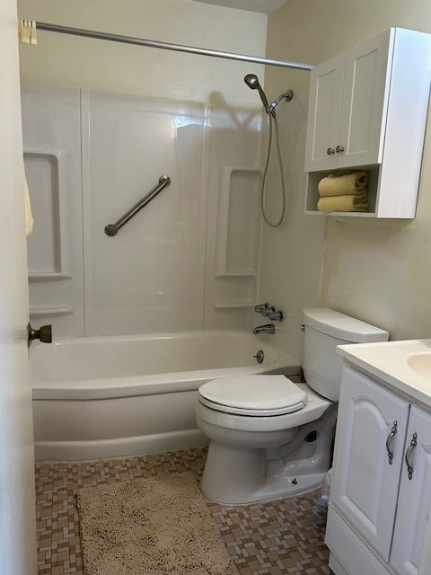 full bath with toilet, shower / bath combination, and vanity