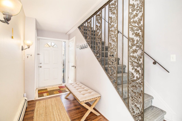 foyer with stairs, baseboards, and wood finished floors