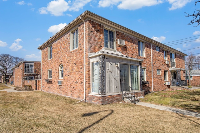 view of home's exterior featuring brick siding and a yard