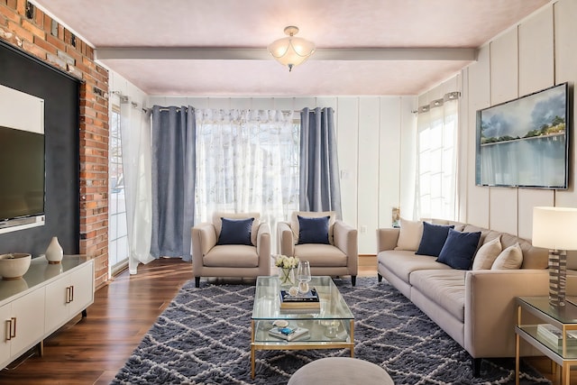 living area with dark wood-type flooring and beam ceiling