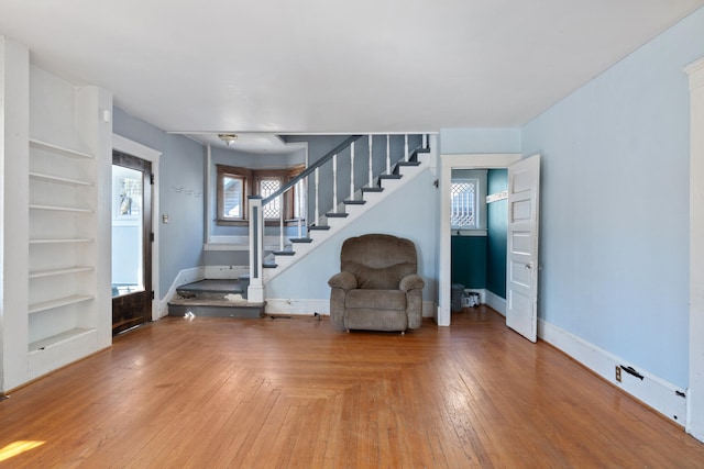 entryway featuring parquet floors, stairway, and baseboards