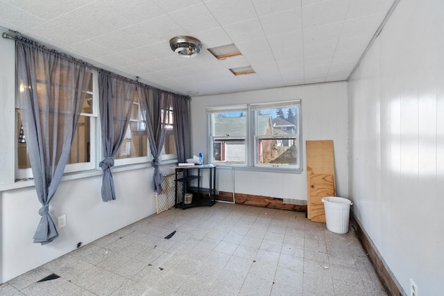 spare room with baseboards and tile patterned floors