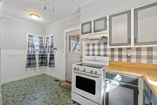 kitchen featuring a wainscoted wall, light countertops, white electric range oven, and under cabinet range hood