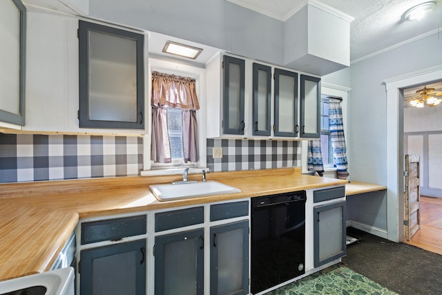 kitchen with a textured ceiling, a sink, light countertops, dishwasher, and crown molding