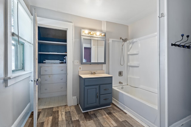 bathroom with vanity, shower / tub combination, and wood finished floors