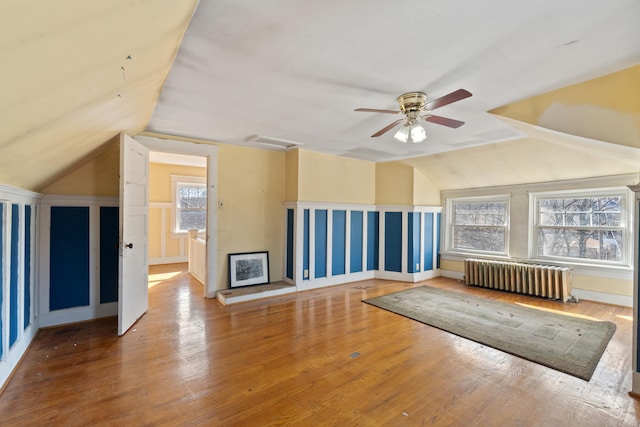 bonus room with lofted ceiling, radiator, ceiling fan, and wood finished floors