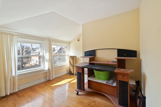 office area with lofted ceiling, wood finished floors, and baseboards