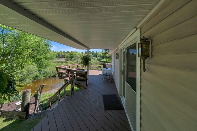 12260 183rd Ave, Big Rapids, MI 49307 - wooden terrace with a water view