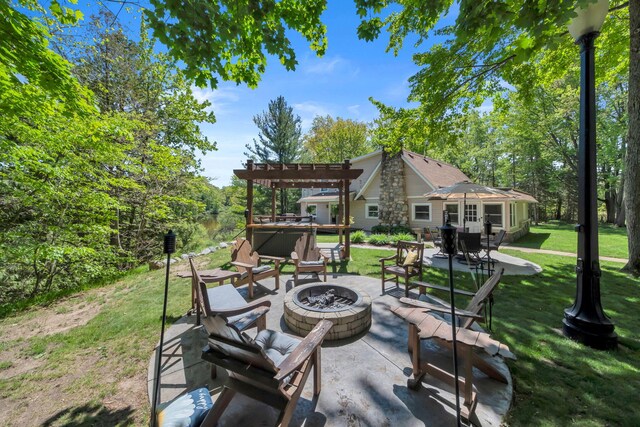 12260 183rd Ave, Big Rapids, MI 49307 - view of patio featuring a fire pit and a pergola