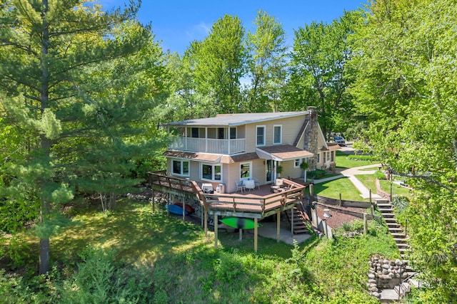 12260 183rd Ave, Big Rapids, MI 49307 - rear view of house with stairway, a deck, and a balcony