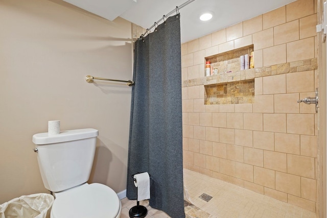 full bath with toilet and a tile shower