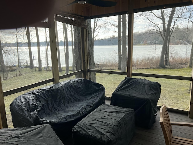 sunroom with a water view and a healthy amount of sunlight