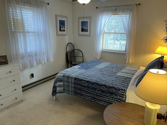 bedroom with carpet and baseboard heating