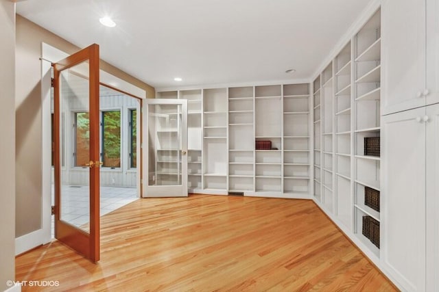 interior space with wood finished floors and french doors