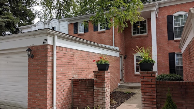 view of side of home featuring brick siding and an attached garage