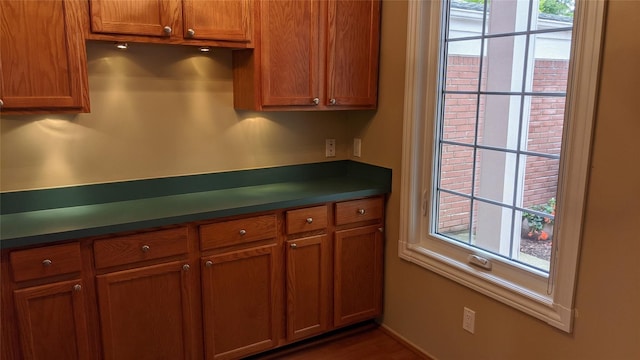 kitchen featuring brown cabinetry and dark countertops