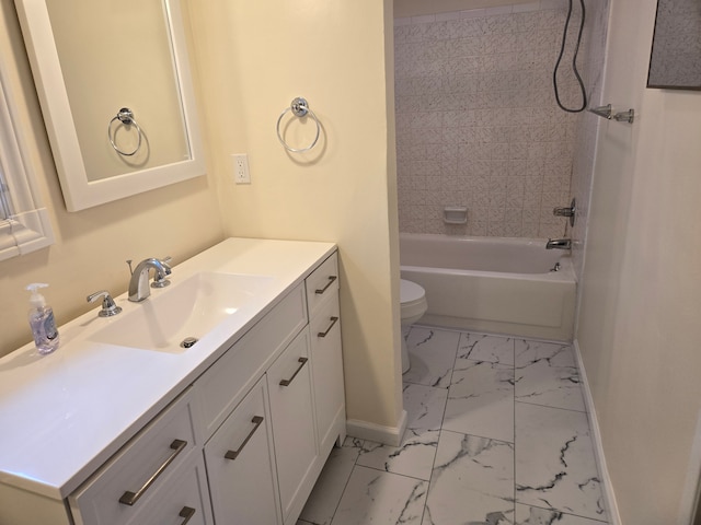 bathroom featuring marble finish floor, toilet, vanity, and baseboards