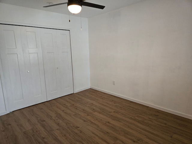 unfurnished bedroom with ceiling fan, a closet, wood finished floors, and baseboards