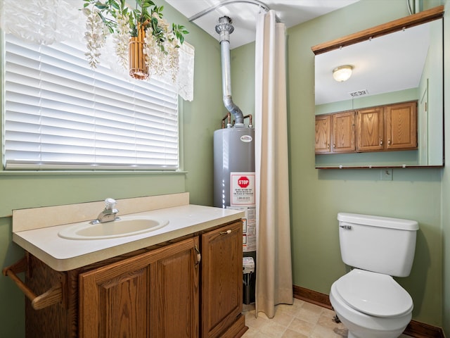 bathroom featuring visible vents, toilet, gas water heater, baseboards, and vanity