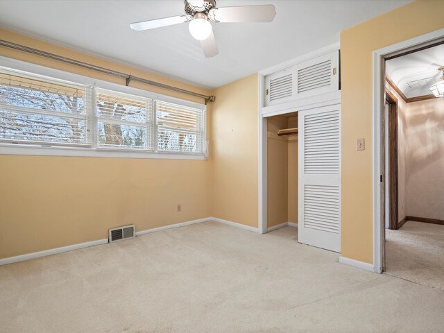 unfurnished bedroom featuring visible vents, ceiling fan, baseboards, light carpet, and a closet