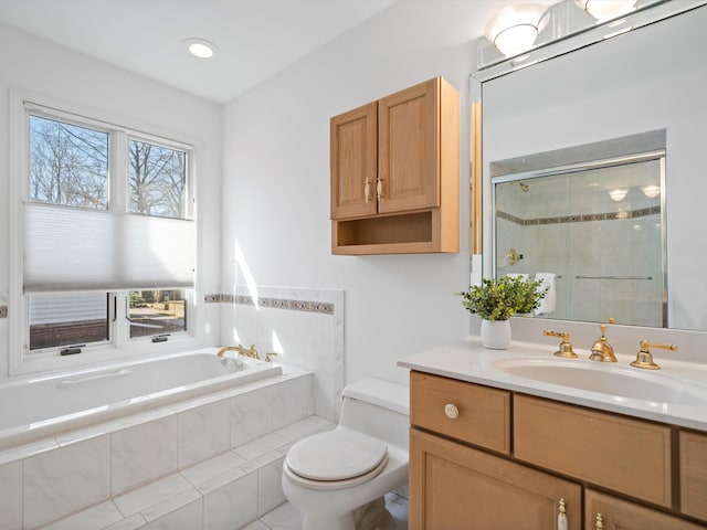 full bath with vanity, a garden tub, a shower stall, and toilet