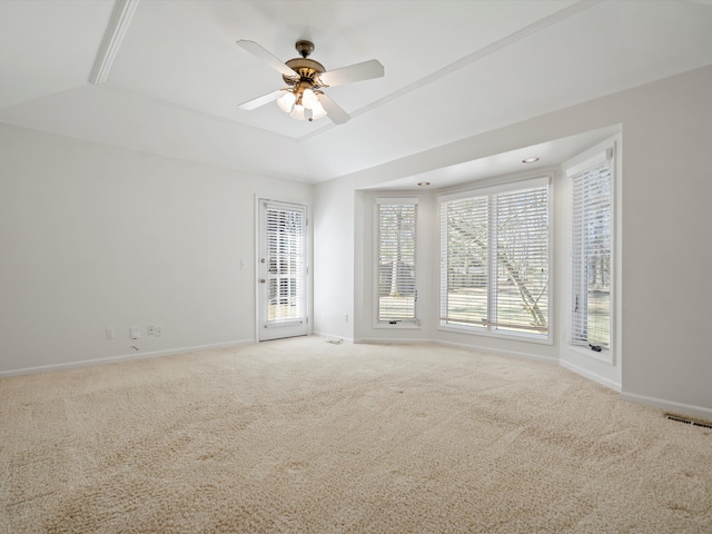 unfurnished room featuring carpet flooring, a ceiling fan, a tray ceiling, and baseboards