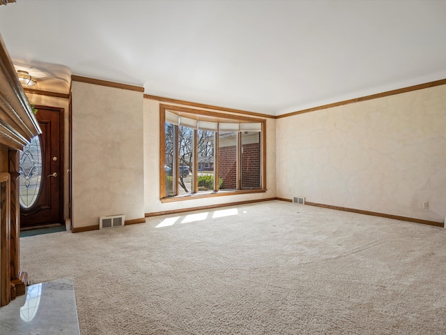 unfurnished living room featuring visible vents, carpet floors, and crown molding