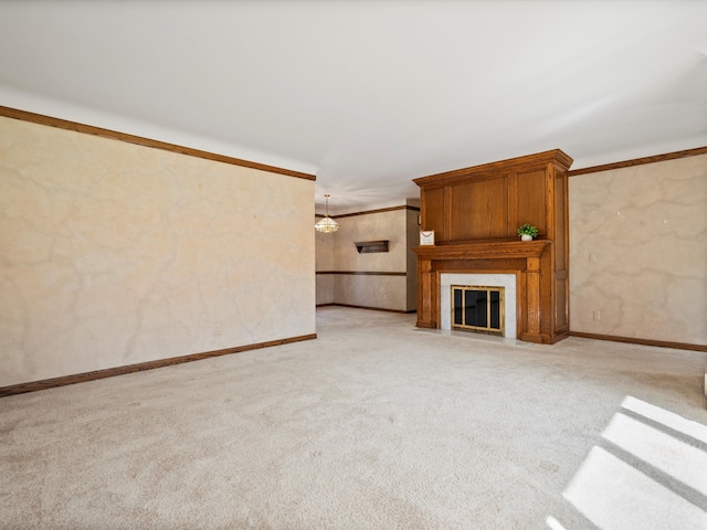 unfurnished living room with baseboards, wallpapered walls, ornamental molding, light colored carpet, and a large fireplace