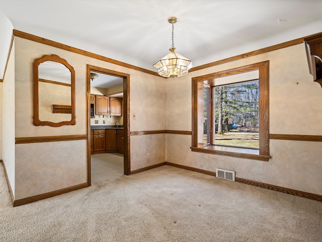 unfurnished dining area with visible vents, light carpet, a notable chandelier, and baseboards