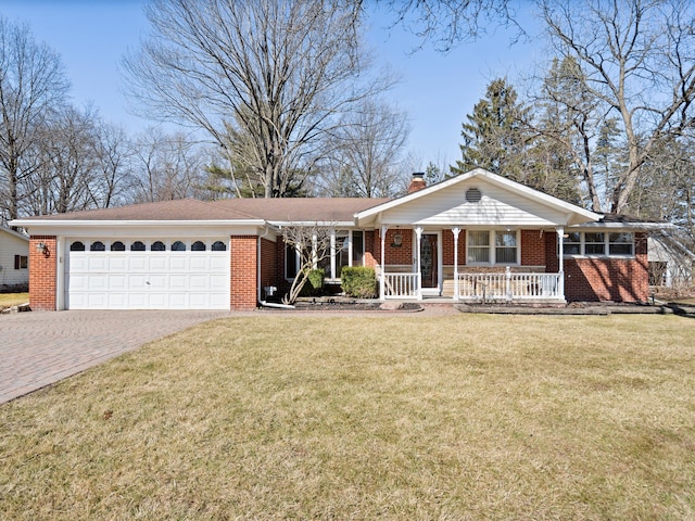 ranch-style home featuring decorative driveway, a front yard, an attached garage, brick siding, and a chimney