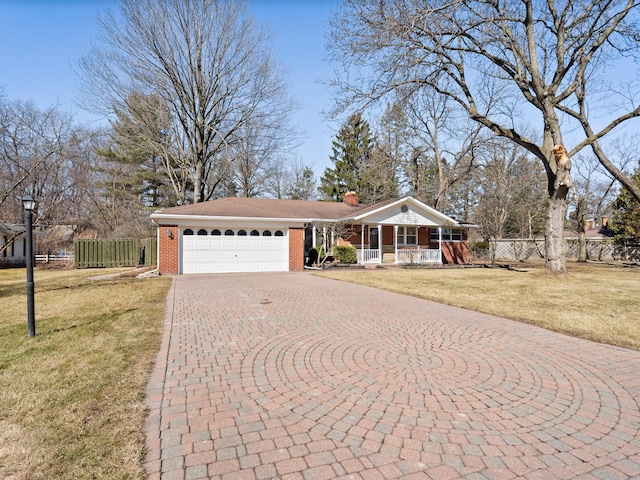 single story home with brick siding, fence, a front yard, covered porch, and decorative driveway