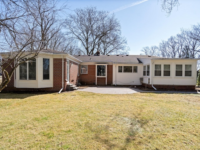 back of property featuring a patio area, crawl space, and a lawn