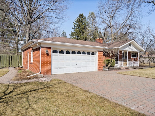 single story home featuring decorative driveway, brick siding, a chimney, and fence