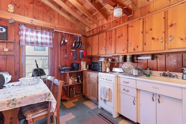 kitchen featuring white electric stove, black microwave, wooden walls, vaulted ceiling, and light countertops