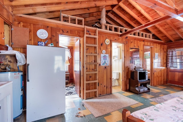 kitchen featuring lofted ceiling, wooden walls, and electric water heater