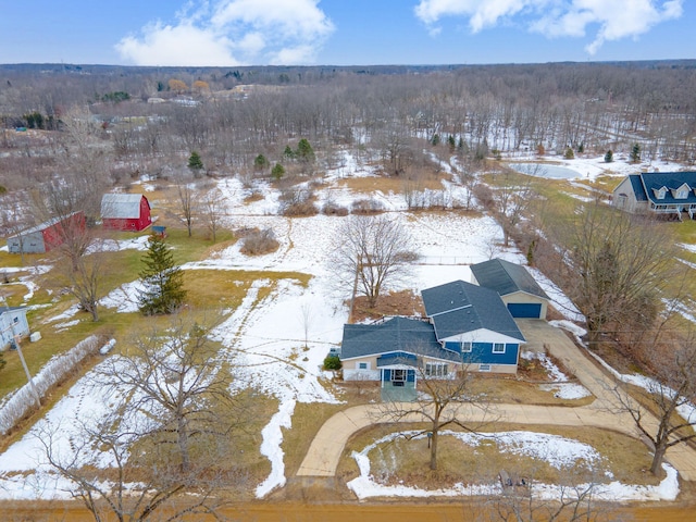 snowy aerial view with a forest view