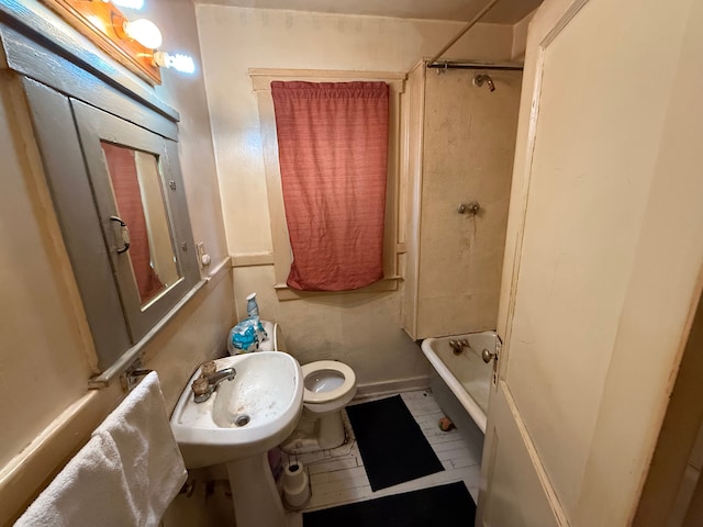 full bath featuring toilet, washtub / shower combination, and a sink