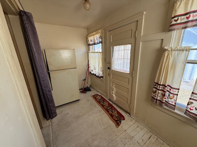 doorway to outside featuring light wood-style floors