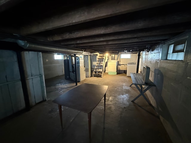 basement with washer and clothes dryer, a sink, and heating unit