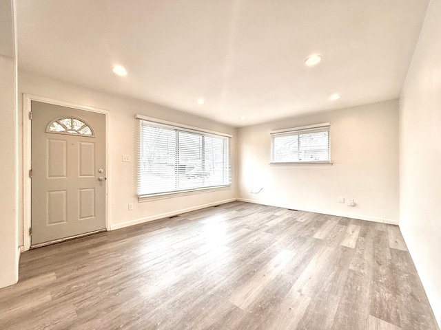 foyer featuring recessed lighting, baseboards, and wood finished floors