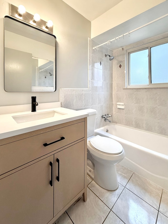 bathroom with shower / bath combination, toilet, tile walls, and vanity