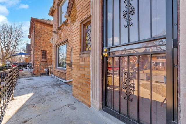 property entrance featuring brick siding