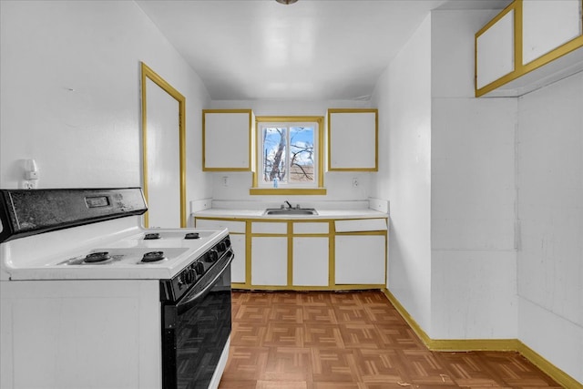 kitchen with white electric stove, baseboards, white cabinets, light countertops, and a sink