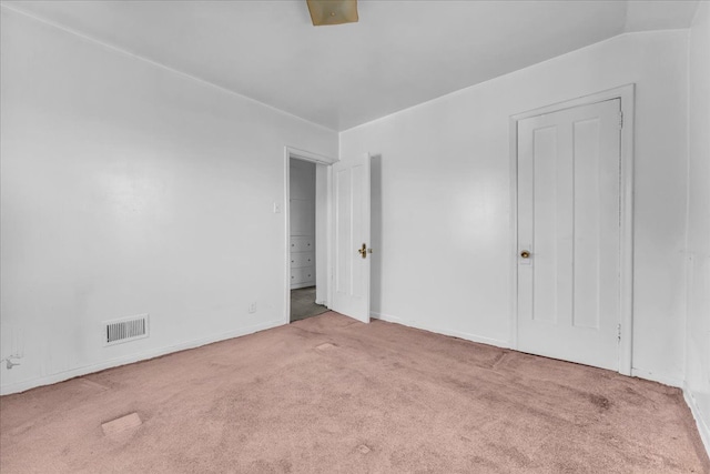 unfurnished bedroom with carpet floors, baseboards, and visible vents